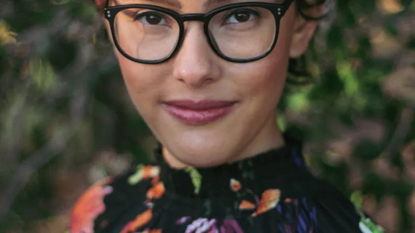 an image of Baylee Shlichtman, a young woman with glasses