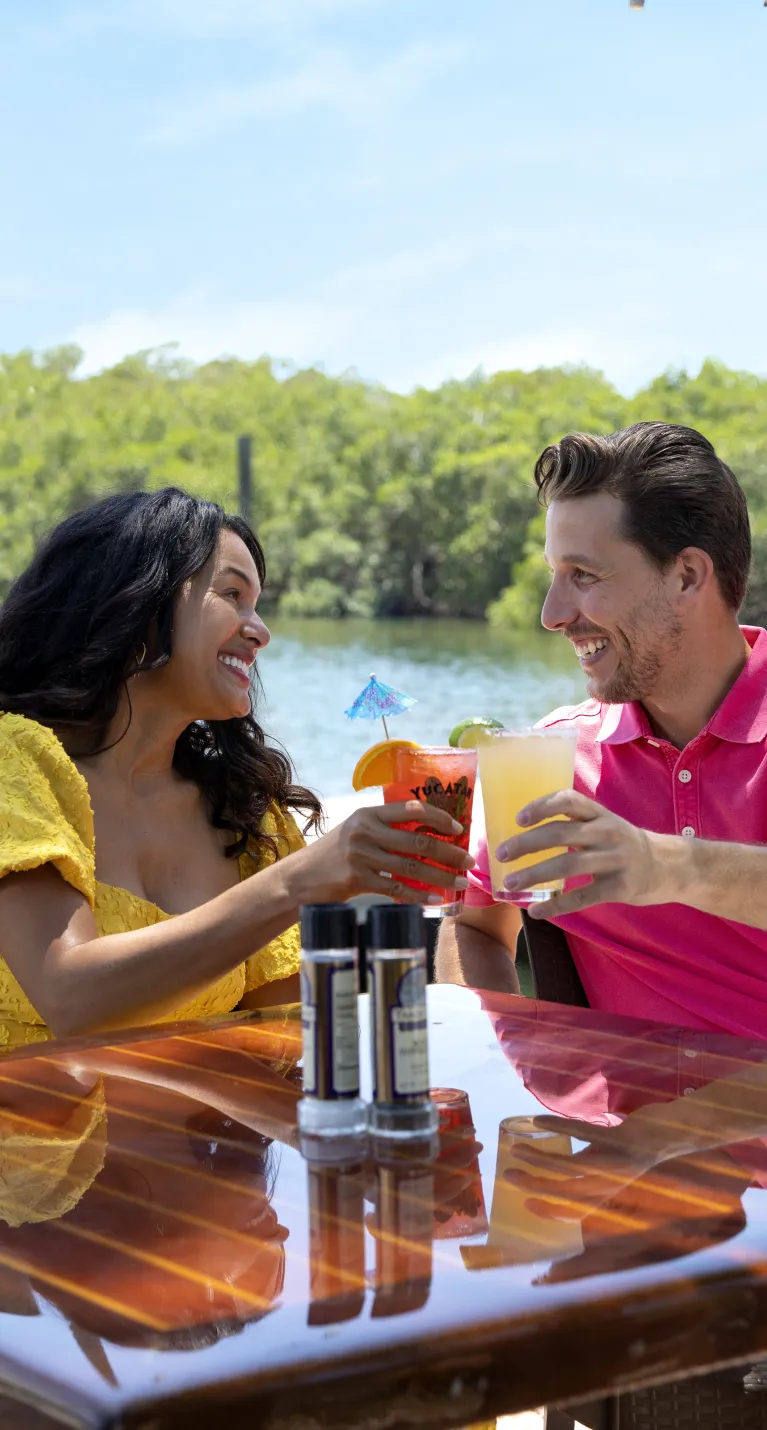 A couple enjoy lunch at a waterside cafe